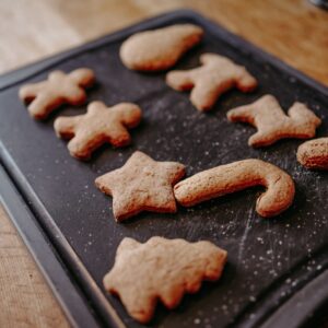 Close-up image of freshly baked Christmas gingerbread cookies cooling on a tray.