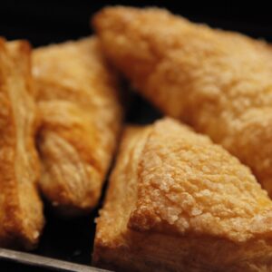 Close-up of golden, flaky pastries perfect for breakfast or dessert.
